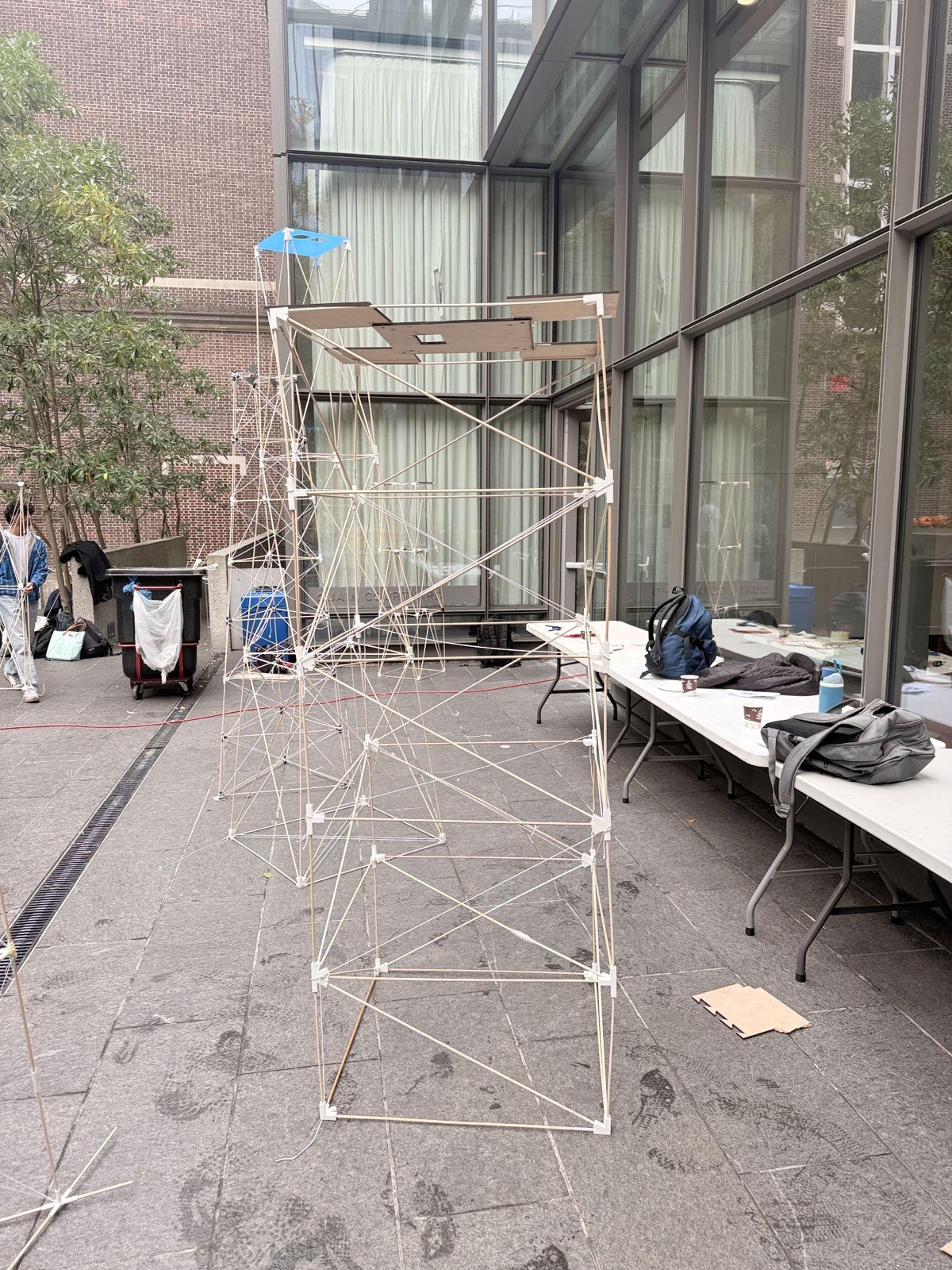 The completed 80-inch dowel-truss water tower standing in a campus courtyard